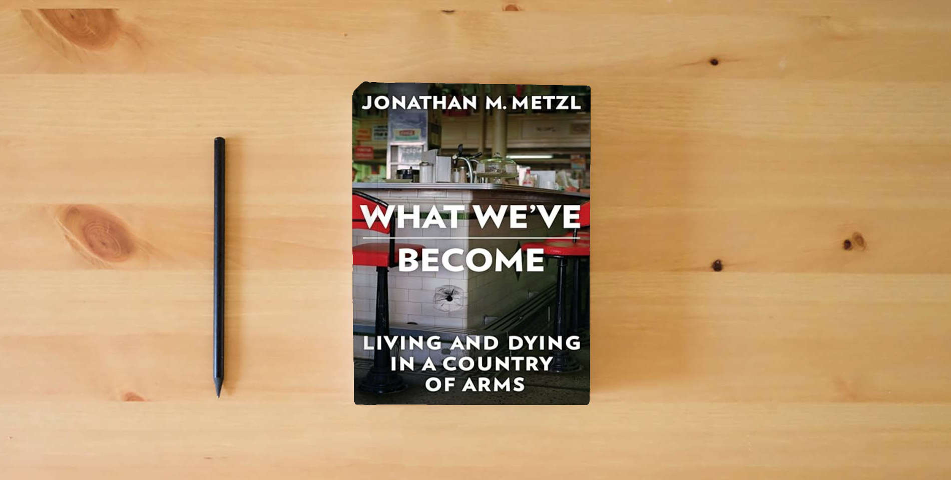 The book What We've Become: Living and Dying in a Country of Arms is on the table