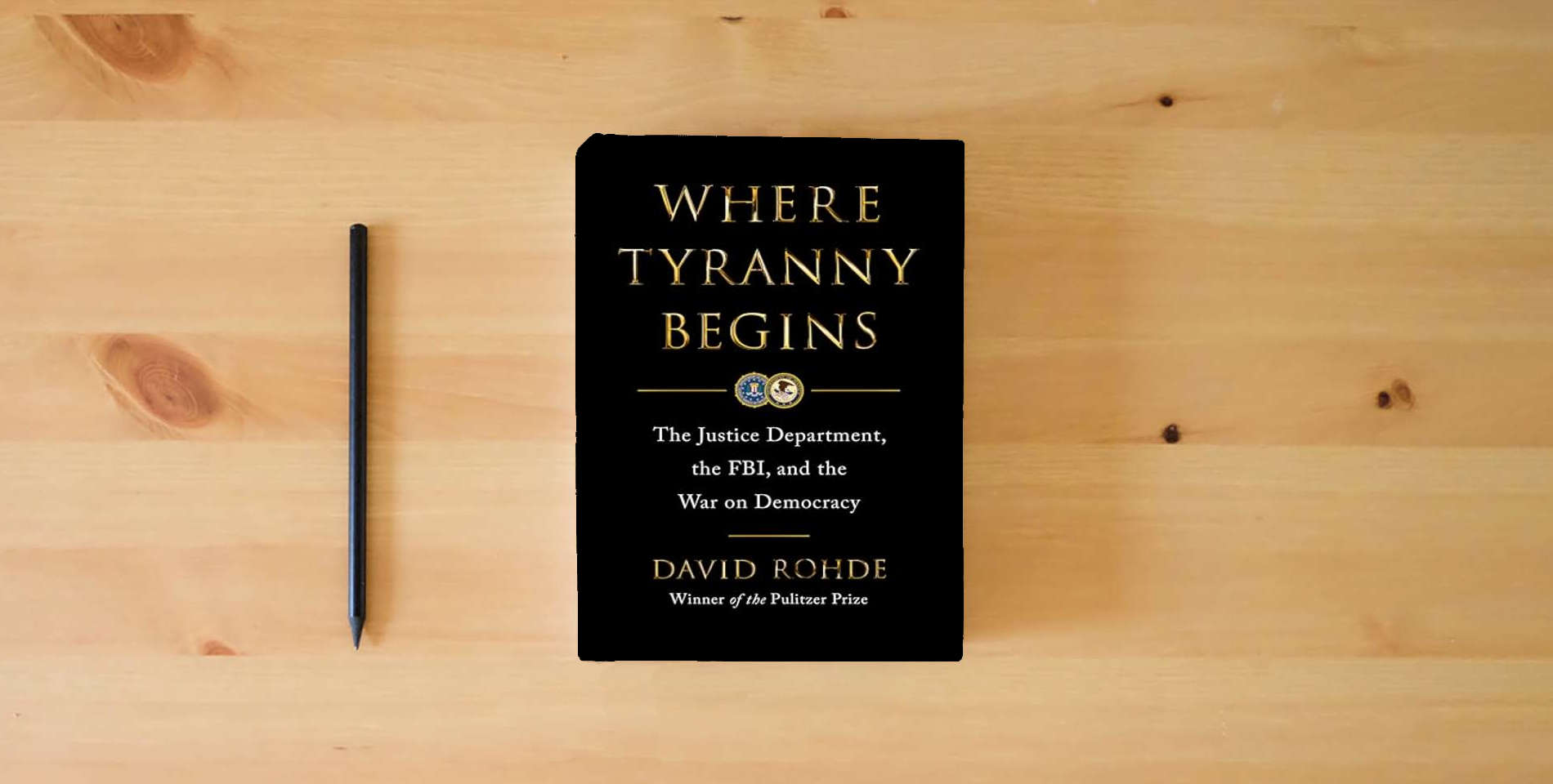 The book Where Tyranny Begins: The Justice Department, the FBI, and the War on Democracy is on the table