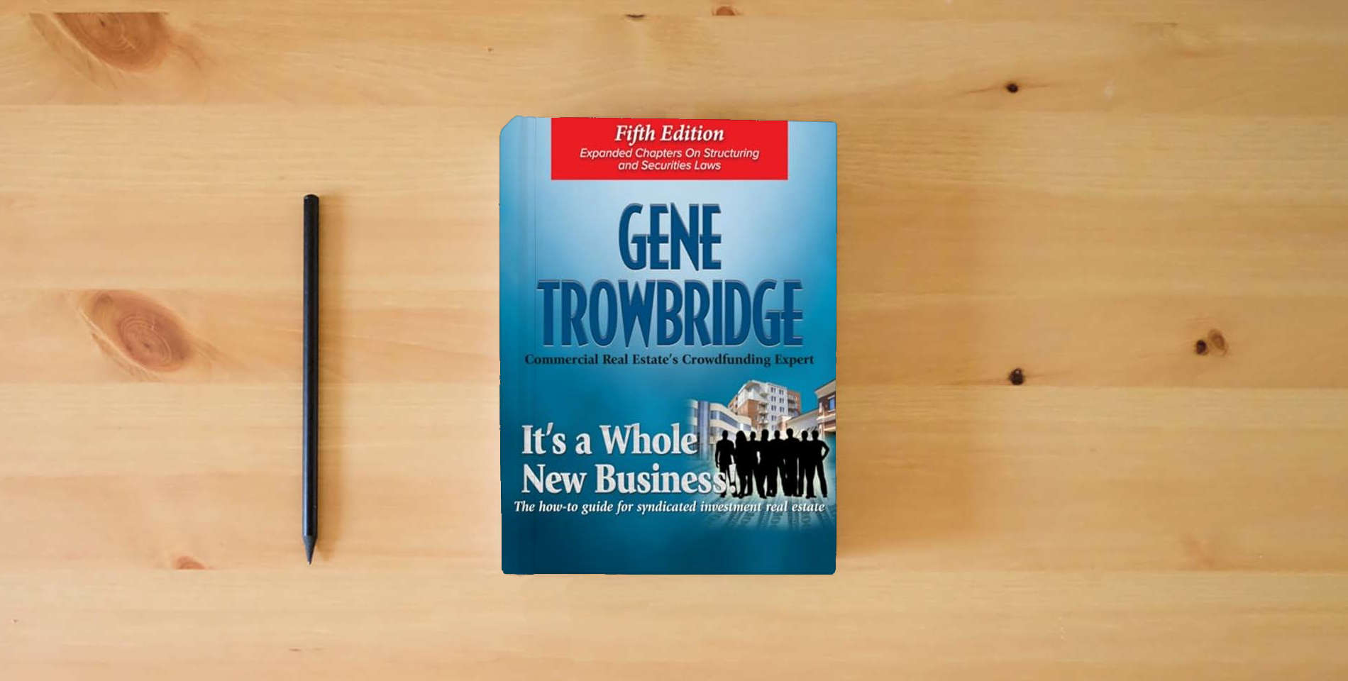 The book It's a Whole New Business, Fifth Edition: The How-To Guide of Syndicated Investment Real Estate is on the table