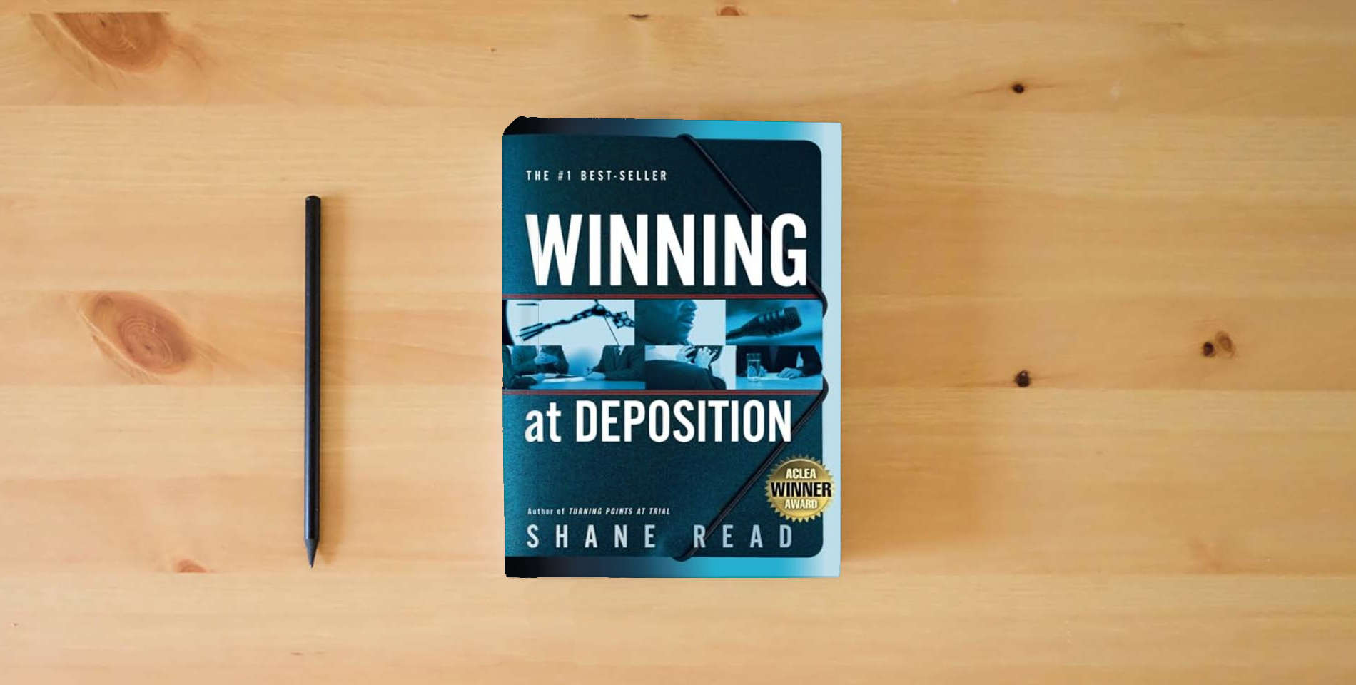 The book Winning at Deposition: (Winner of ACLEA's Highest Award for Professional Excellence) is on the table