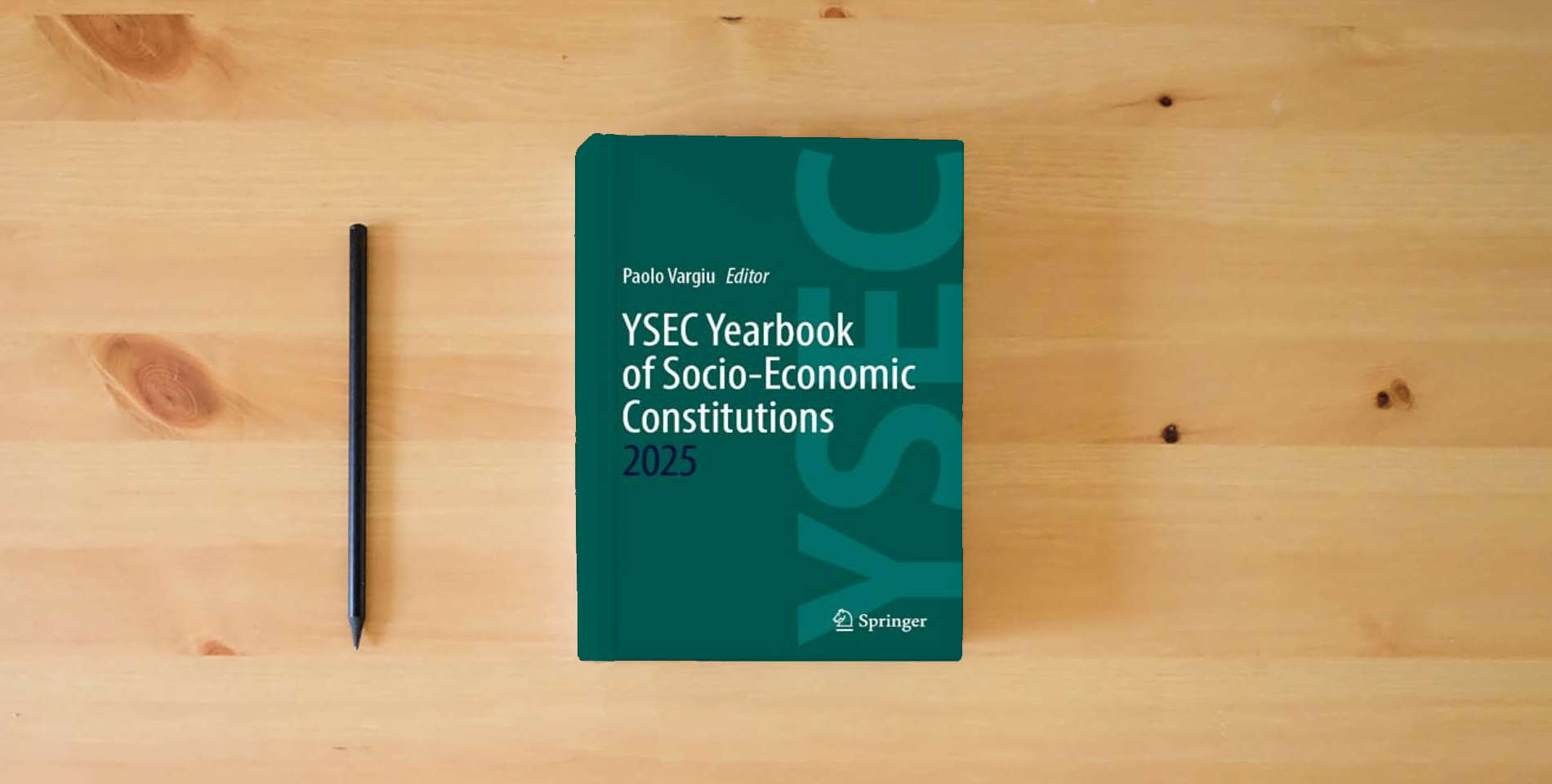 The book YSEC Yearbook of Socio-Economic Constitutions 2025 is on the table