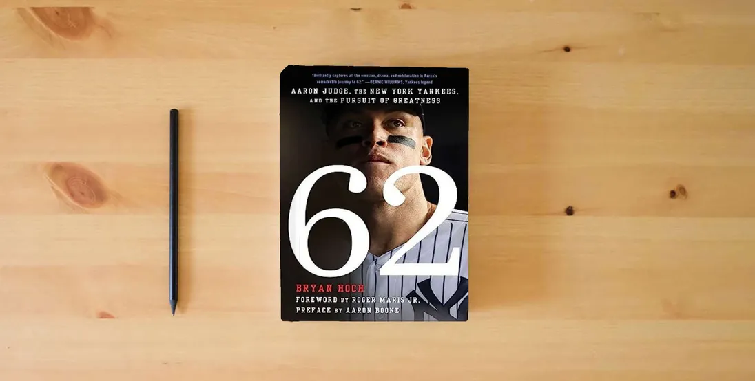 The book 62: Aaron Judge, the New York Yankees, and the Pursuit of Greatness} is on the table