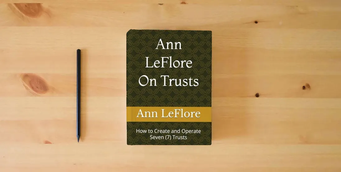The book Ann Leflore - On Trusts: How to Create and Operate Seven (7) Trusts} is on the table