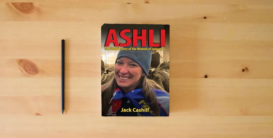 The book ASHLI: The Untold Story of the Women of January 6} is on the table