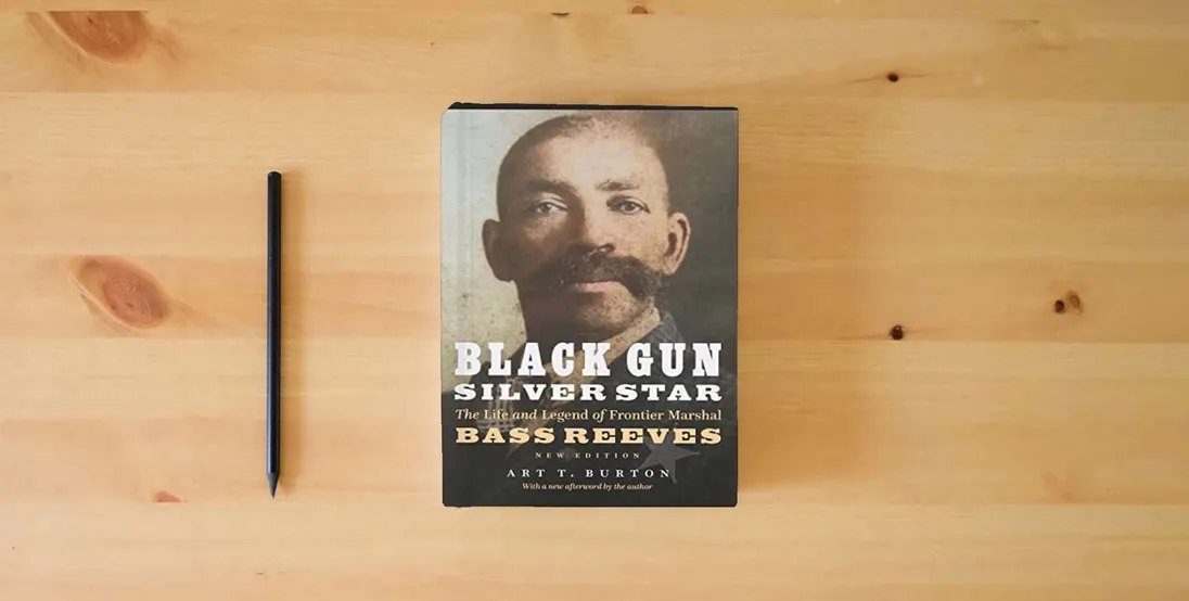The book Black Gun, Silver Star: The Life and Legend of Frontier Marshal Bass Reeves (Race and Ethnicity in the American West)} is on the table