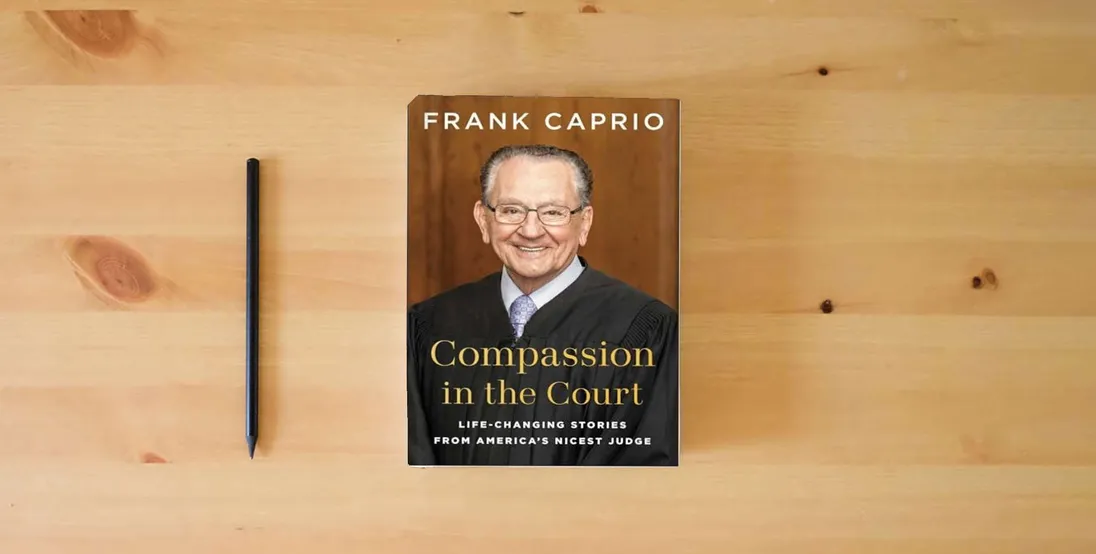 The book Compassion in the Court: Life-Changing Stories from America's Nicest Judge} is on the table