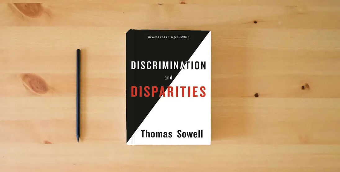 The book Discrimination and Disparities} is on the table
