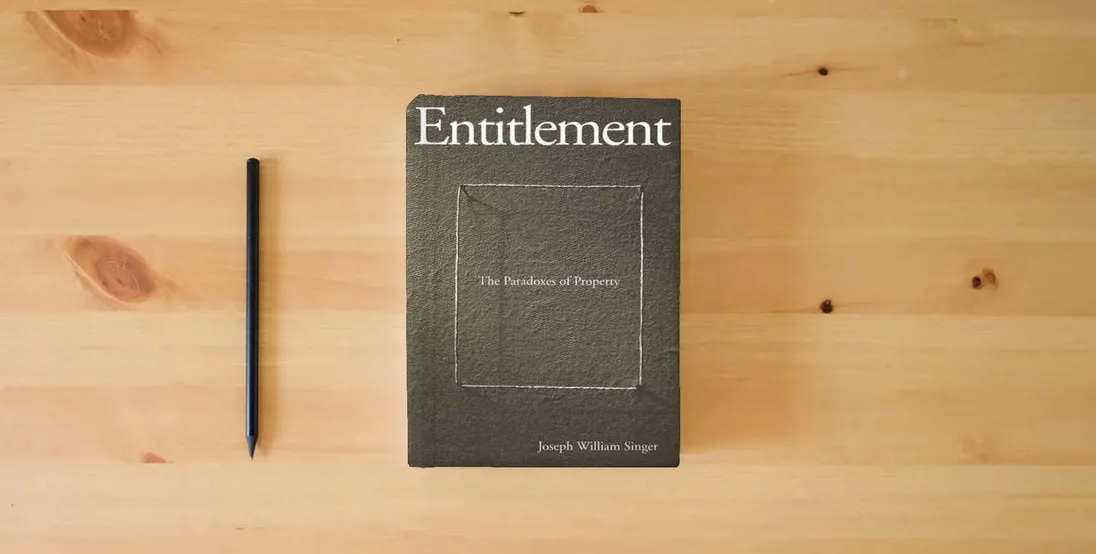 The book Entitlement: The Paradoxes of Property} is on the table
