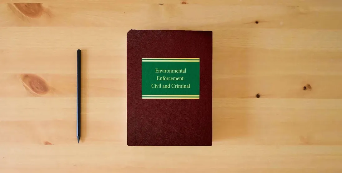 The book Environmental Enforcement: Civil and Criminal (Environmental Law Series)} is on the table