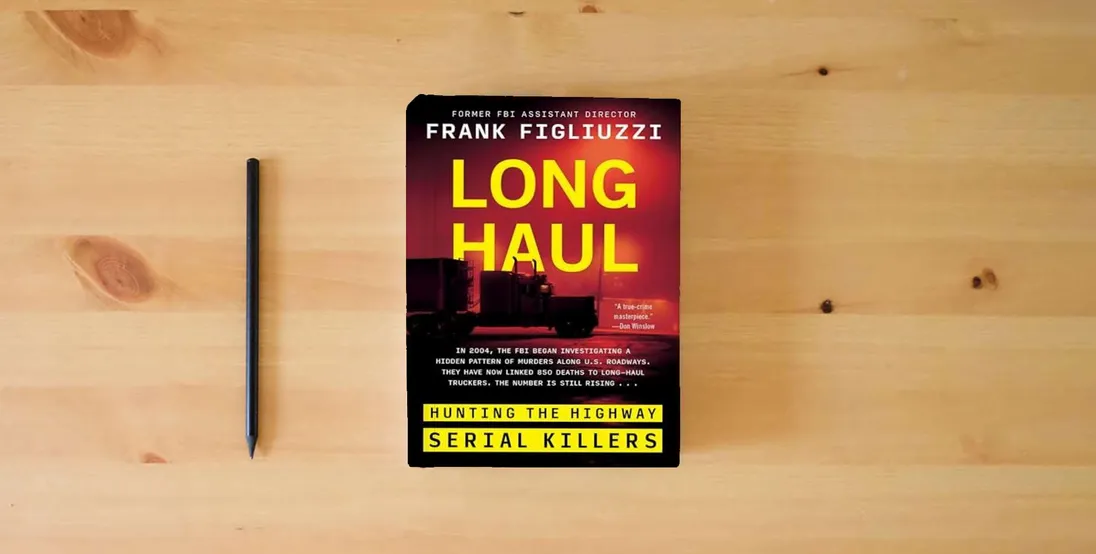 The book Long Haul: Hunting the Highway Serial Killers} is on the table