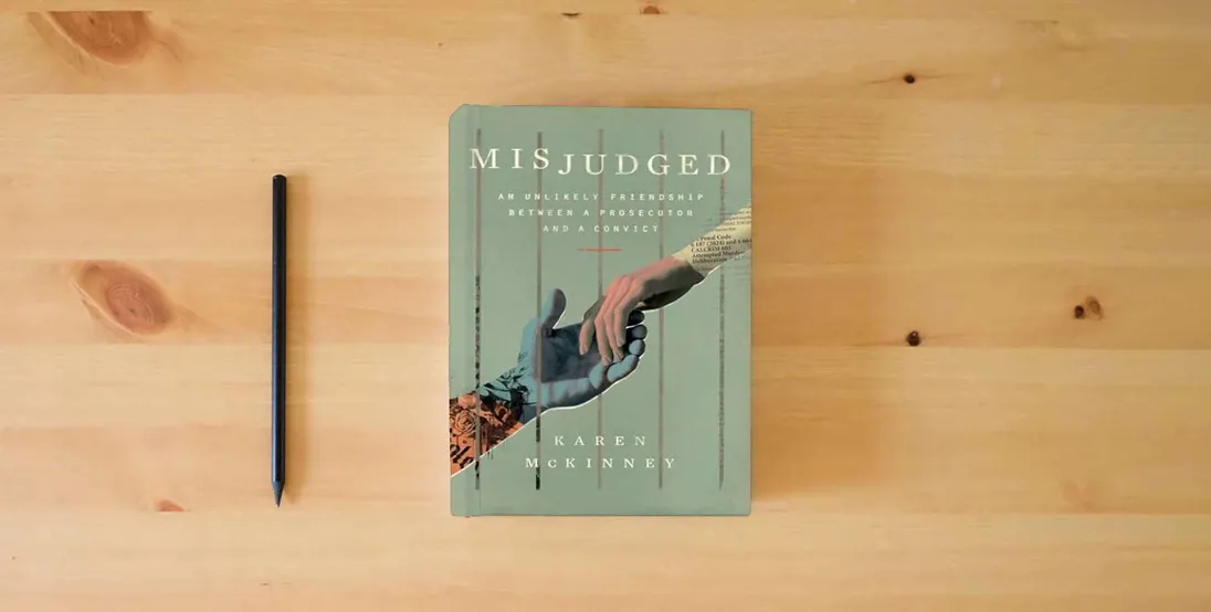 The book Misjudged: An Unlikely Friendship Between a Prosecutor and a Convict} is on the table