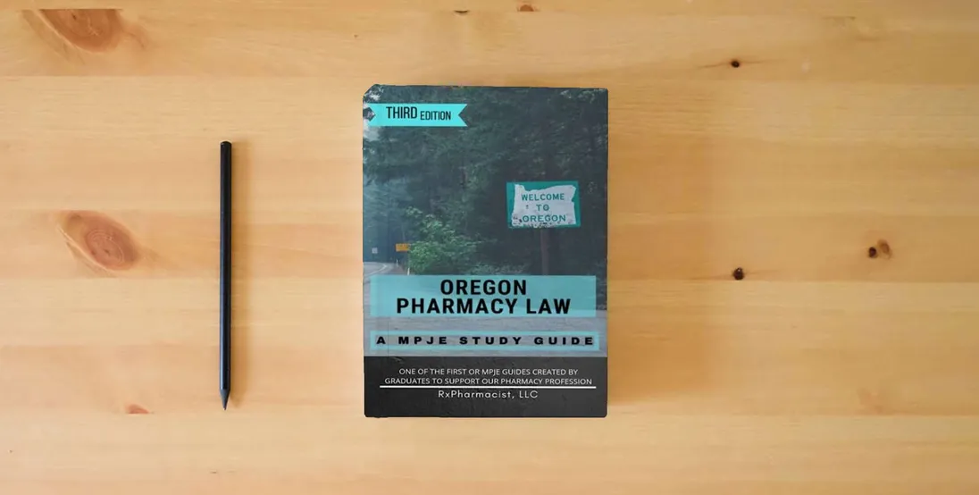 The book Oregon Pharmacy Law: A MPJE Study Guide} is on the table