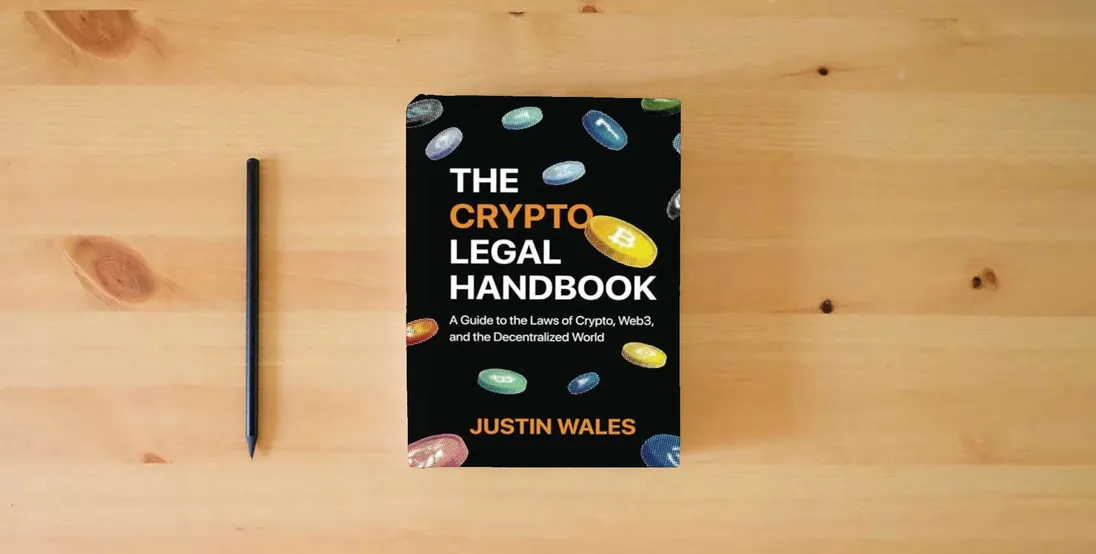 The book The Crypto Legal Handbook: A Guide to the Laws of Crypto, Web3, and the Decentralized World} is on the table