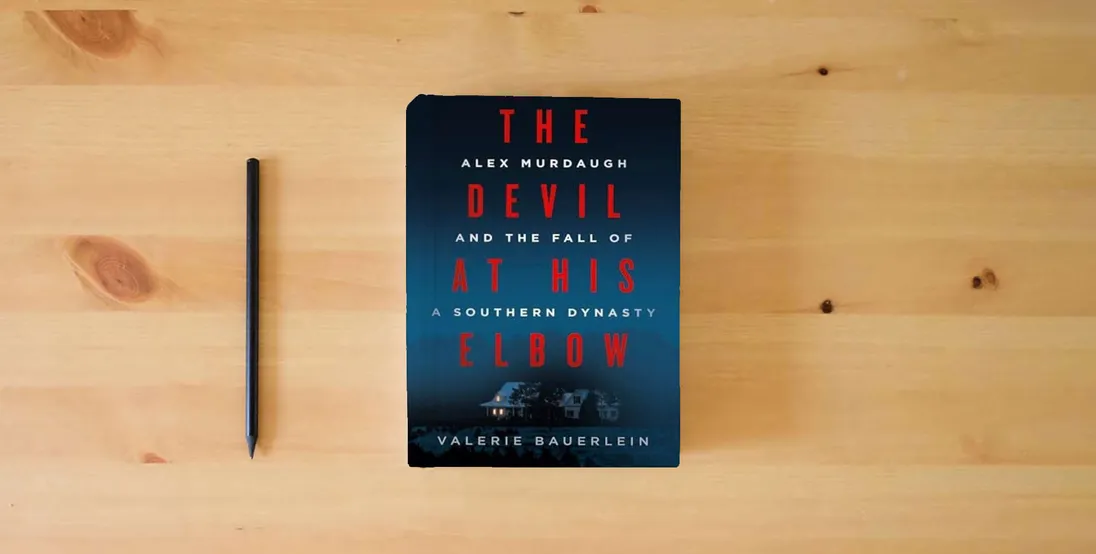 The book The Devil at His Elbow: Alex Murdaugh and the Fall of a Southern Dynasty} is on the table