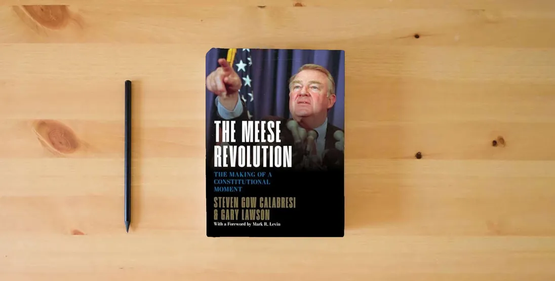 The book The Meese Revolution: The Making of a Constitutional Moment} is on the table