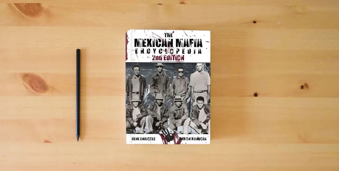 The book The Mexican Mafia Encyclopedia (2nd Edition)} is on the table