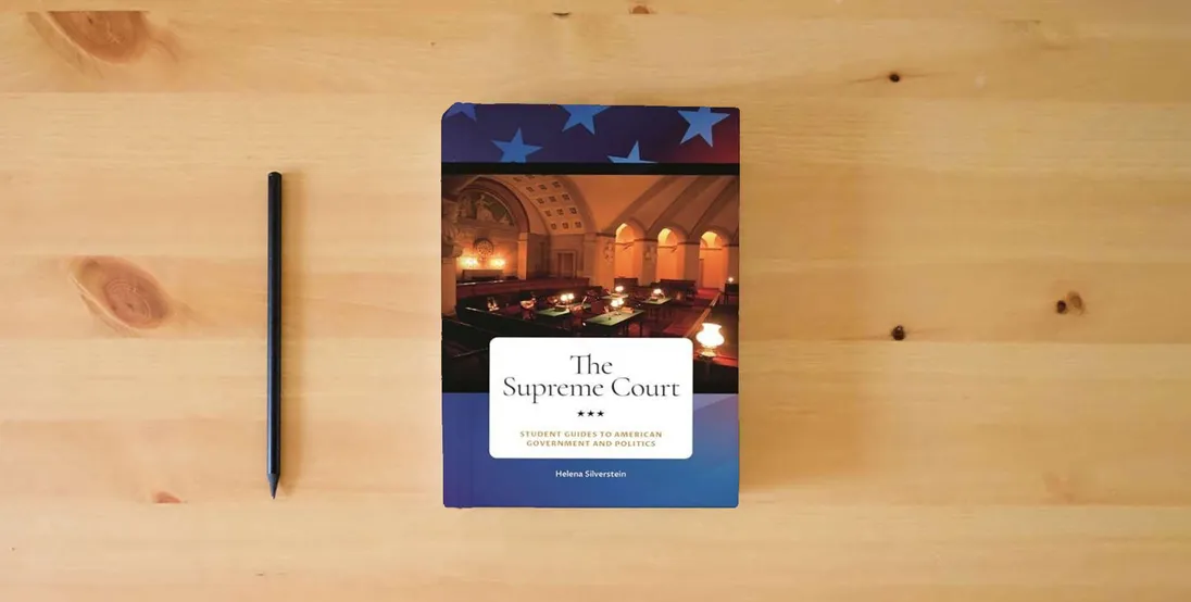 The book The Supreme Court (Student Guides to American Government and Politics)} is on the table