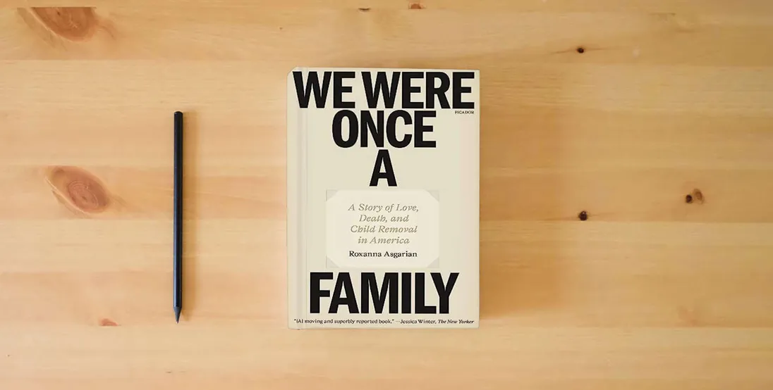 The book We Were Once a Family: A Story of Love, Death, and Child Removal in America} is on the table