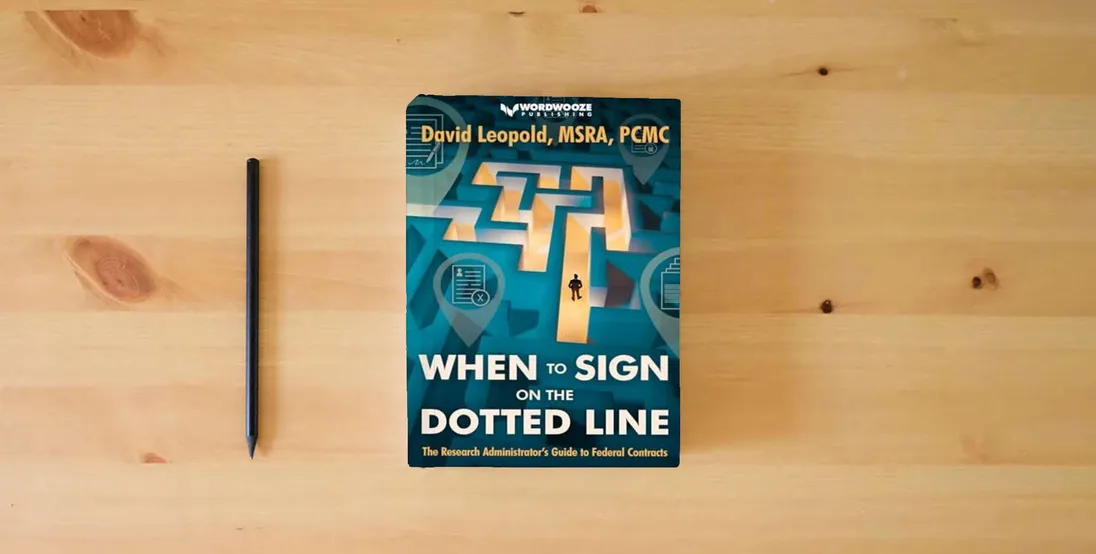 The book When to Sign on the Dotted Line: The Research Administrator’s Guide to Federal Contracts} is on the table